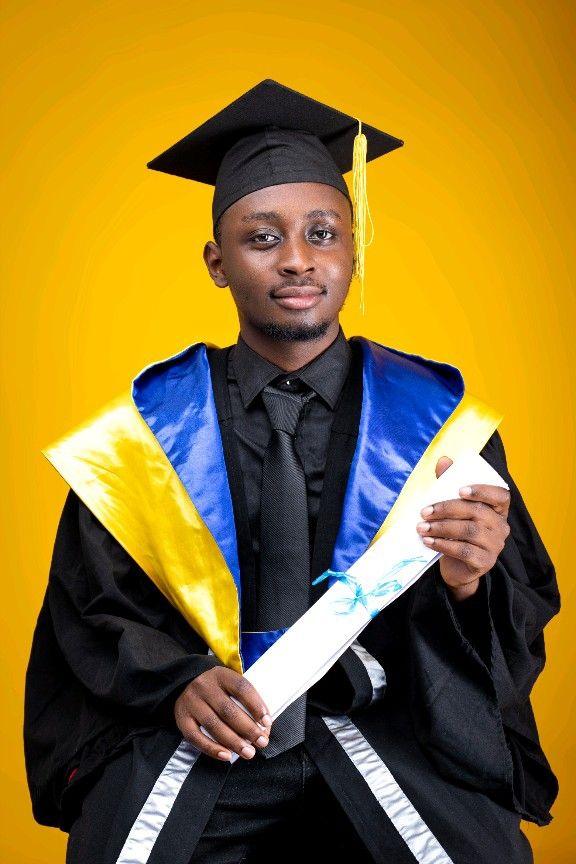 Graduation portrait in cap and gown, holding a degree certificate